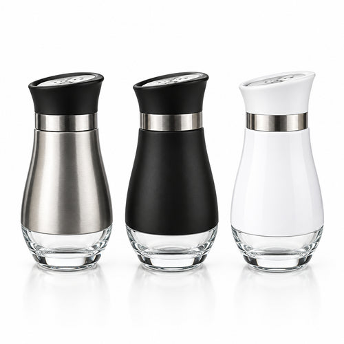 Three modern glass condiment or oil bottles with clear bases are lined up on a dark granite kitchen countertop. The bottles have different body colors: brushed silver, matte black, and glossy white, each with a matching colored upper section and a metallic silver collar.