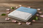 Champagne Lenox Tablecloth in Package on Wooden Table with Rose Petals and Green Leaves