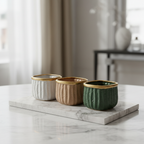 Ceramic ribbed mini planters in multiple colors on marble surface