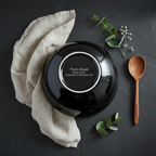 High-glaze black stoneware bowl bottom showing Porto Brasil - Made in Brazil - Dishwasher & Microwave Safe inscription