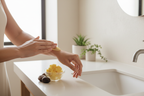 Woman Applying Refined Shea Butter to Skin